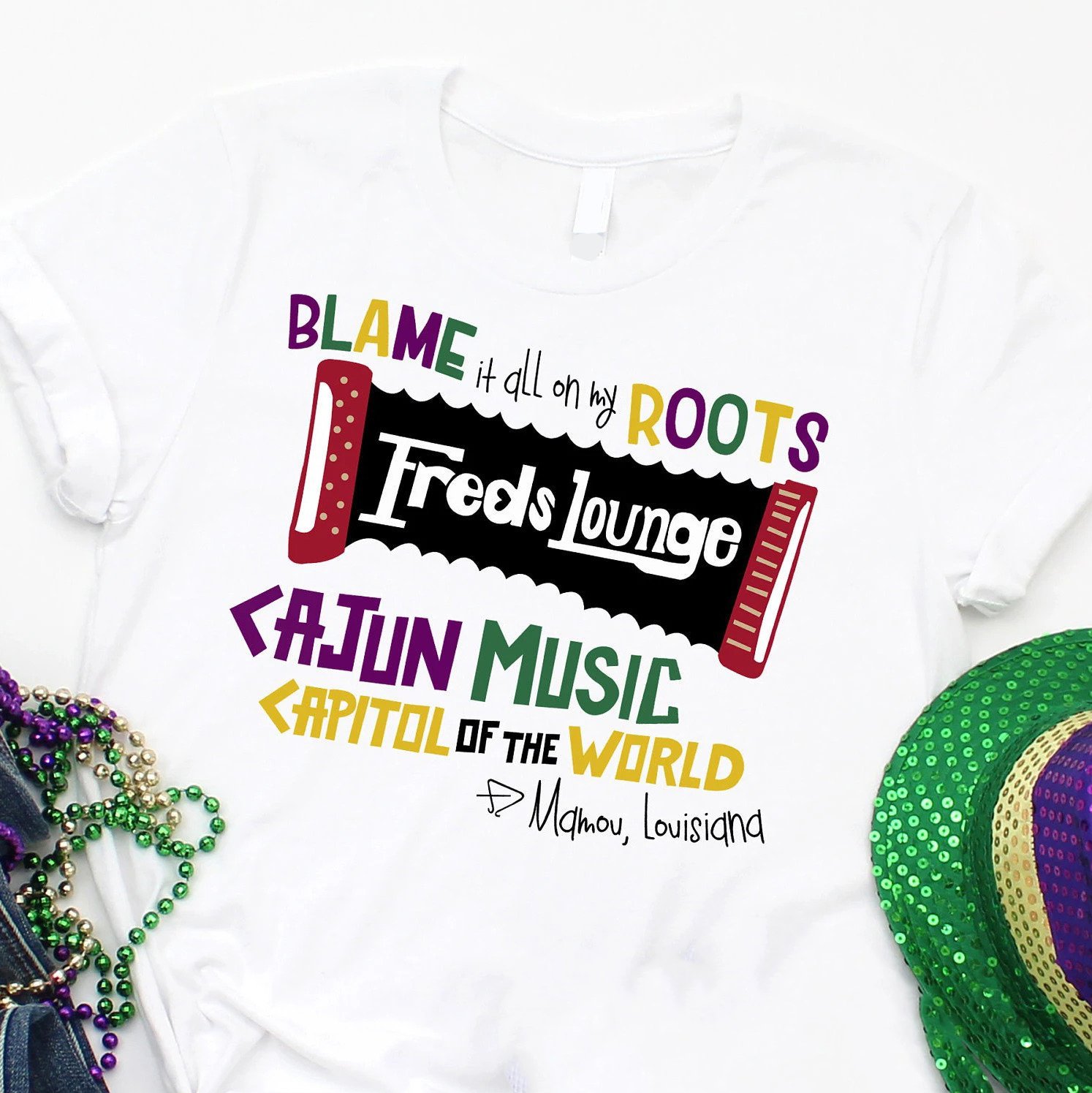 Mardi gras ? Freds lounge mardi gras blame it all on my roots tshirt ? GST